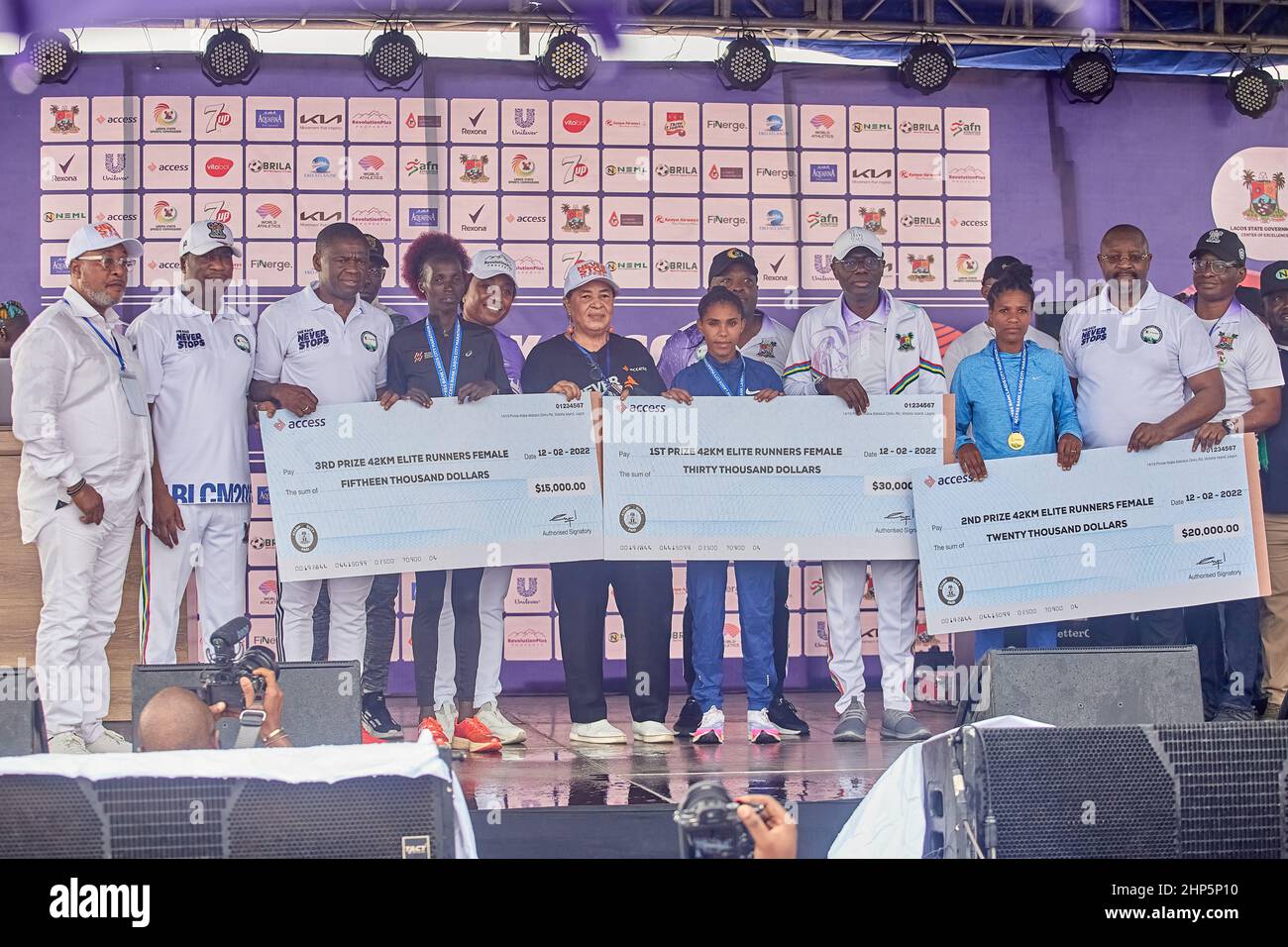 Female marathon winners are pictured with their medal and prize money