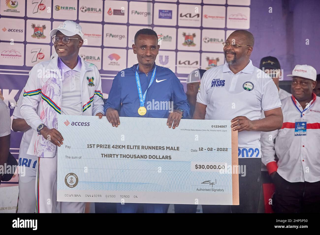 1st place marathon winner, Geleta Ulfata receives a medal and prize money after competing in the Access Bank Lagos City Marathon on February 12, 2022. Stock Photo