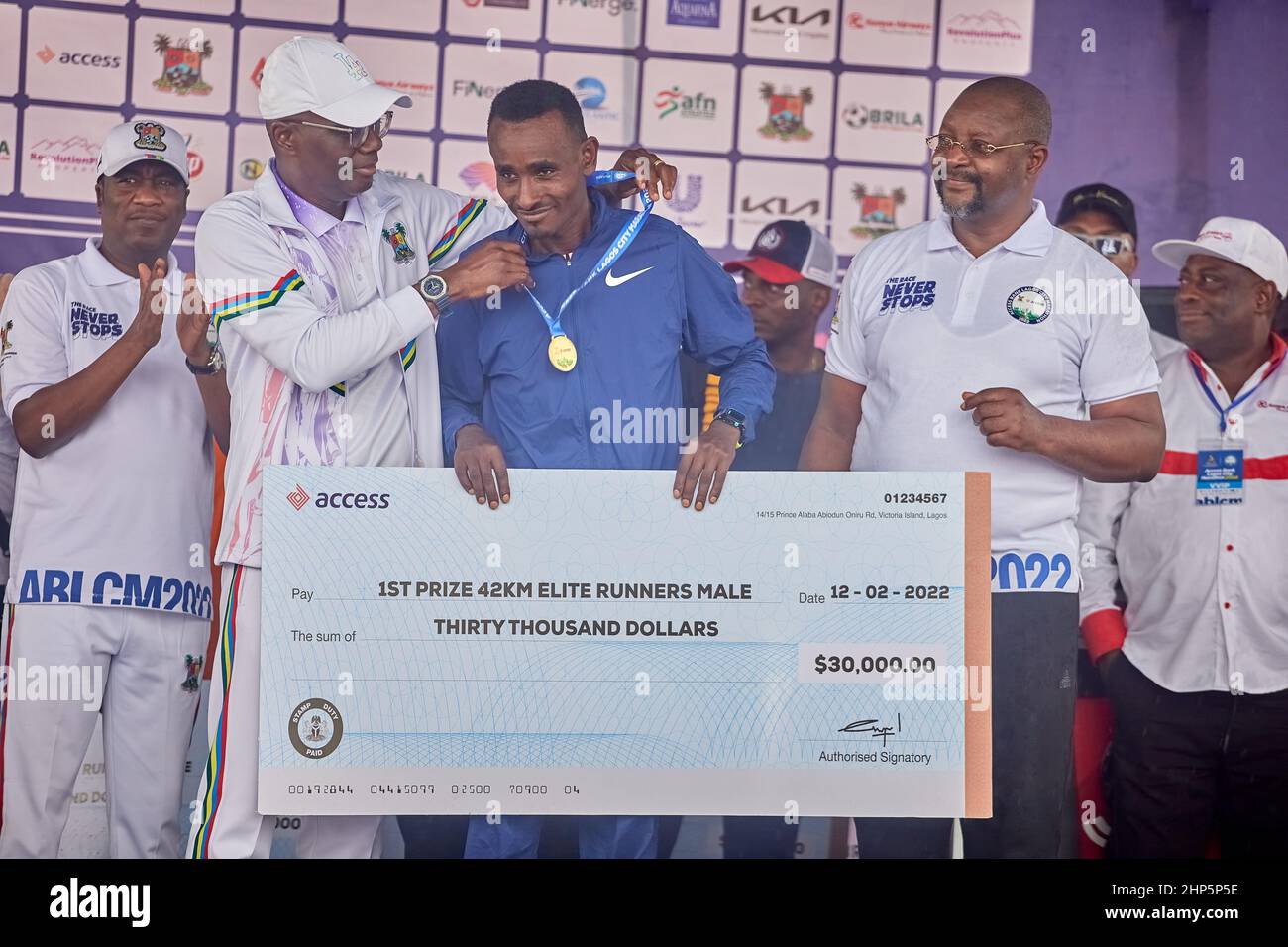 1st place marathon winner, Geleta Ulfata receives a medal and prize money after competing in the Access Bank Lagos City Marathon on February 12, 2022. Stock Photo