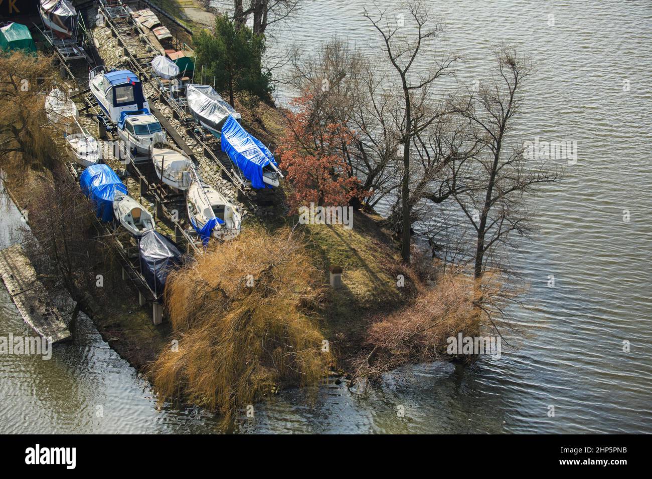 Small boats in dry dock and stored and covered for the winter on Cisarska Louka Island,River Vltava, Smichov district,Vysehrad, Prague, Czech Republic Stock Photo