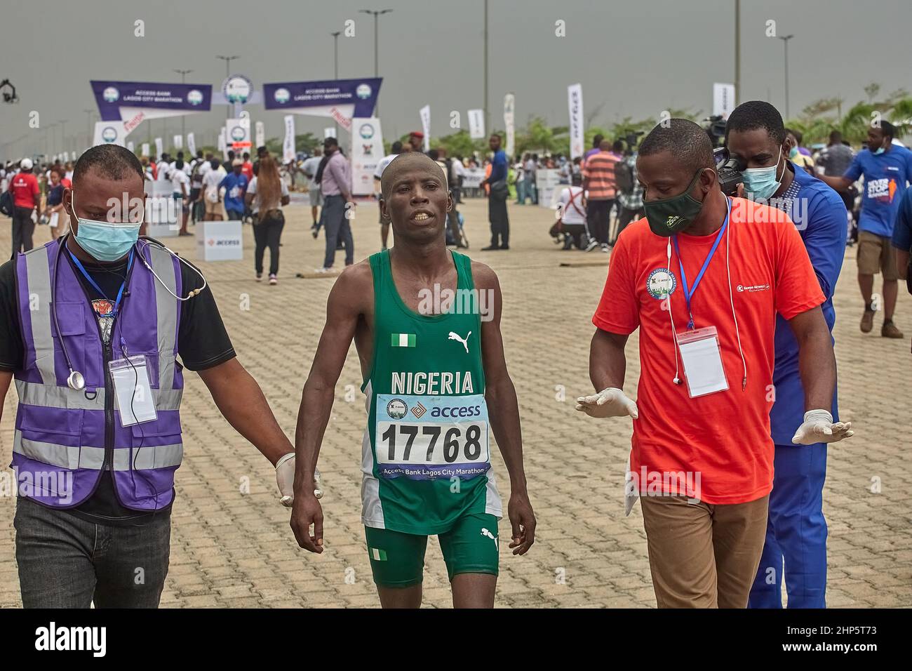 Medics help athletes after competing in the Access Bank Lagos City Marathon, a 42km Silver-Label Race held in Lagos, Nigeria on February 12, 2022. Stock Photo