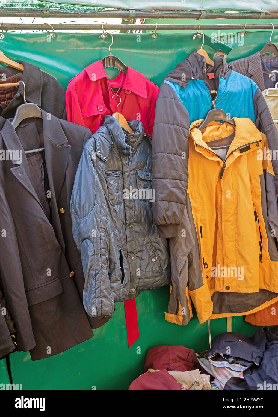 Colorful warm jackets with waterproof materials as protection from rain and snow sold on market during cold weather Stock Photo