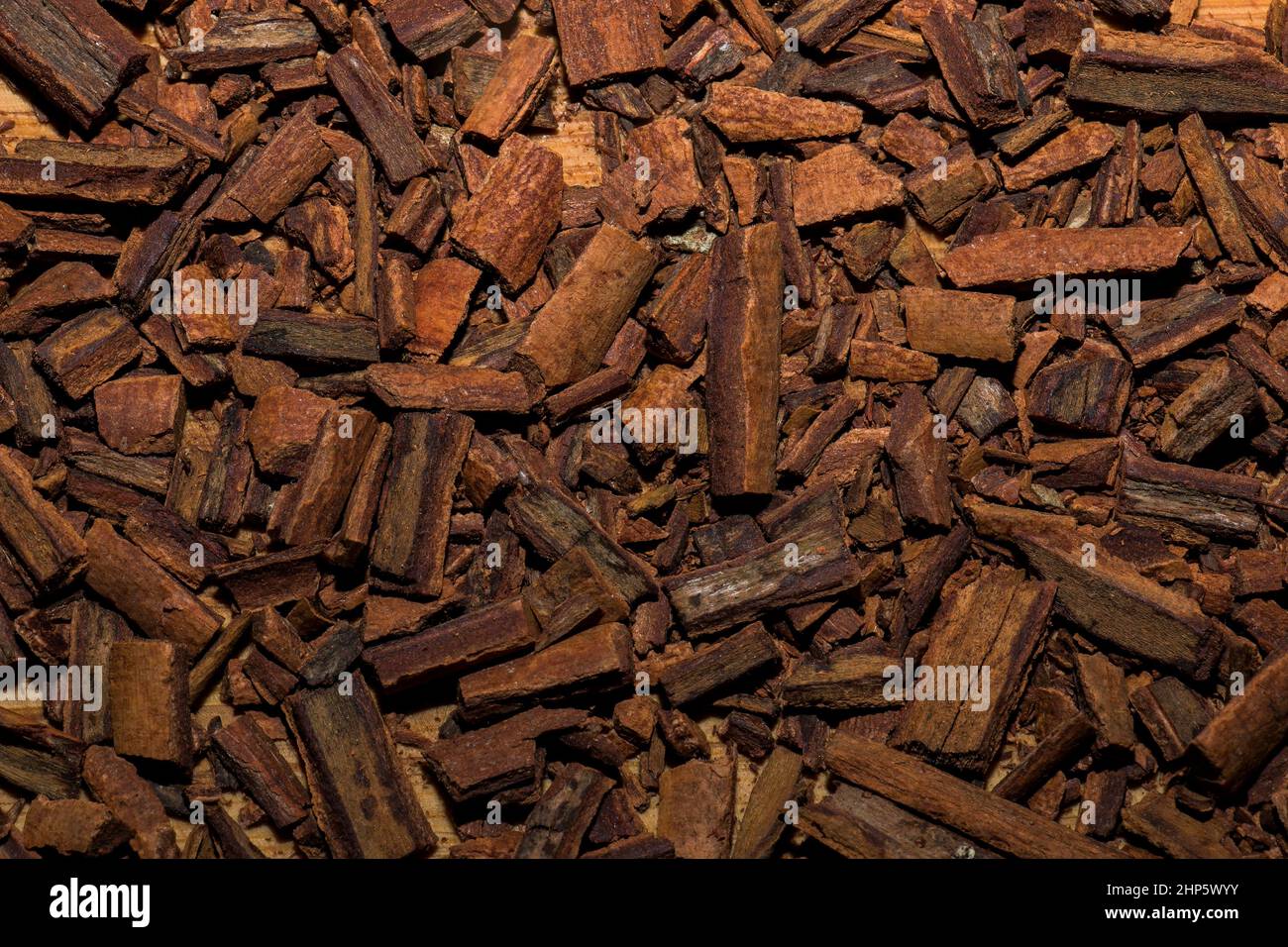 Background of crushed cinnamon sticks for making a tea mixture. Cinnamon texture. Healthy food concept. Stock Photo