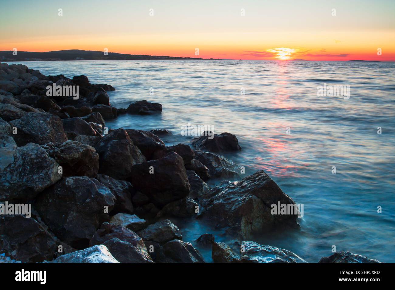 Rocky coastline and blue sky on island Vir, Croatia. Evening sunset with pastel colours of sky. Stock Photo