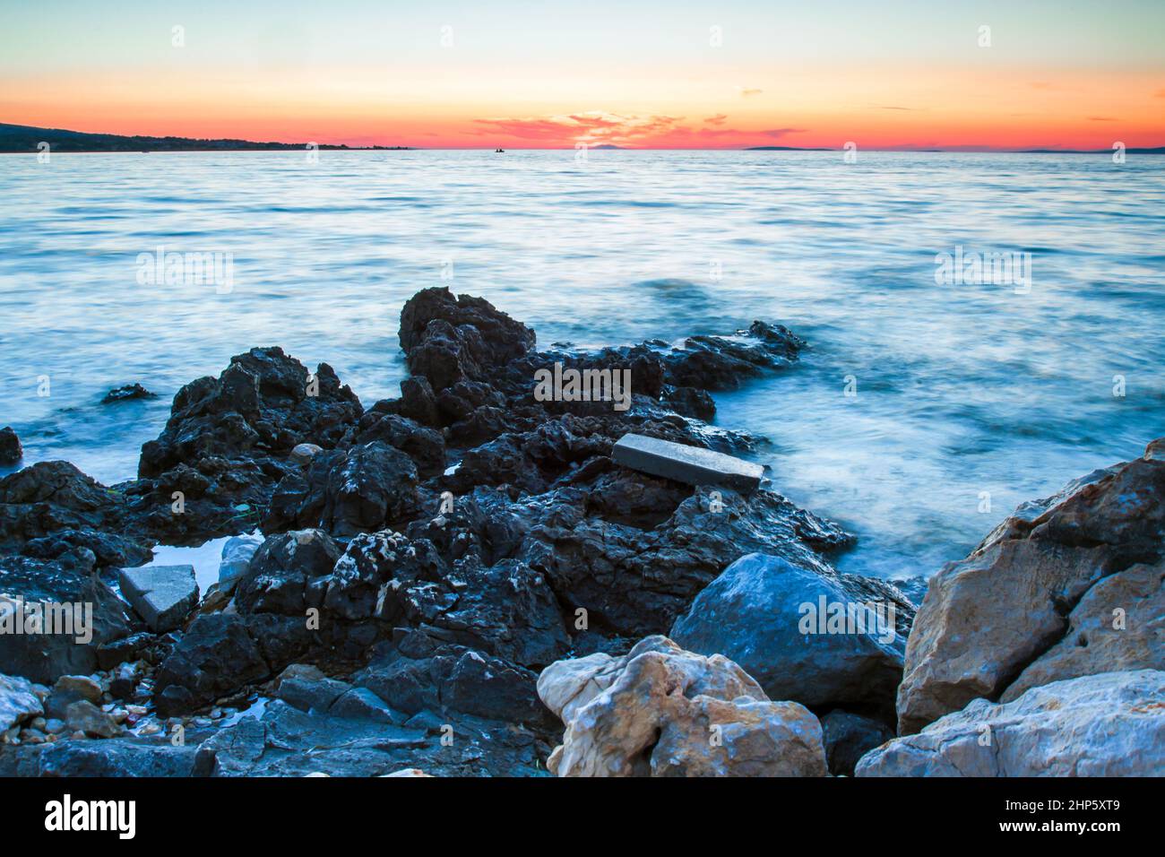 Rocky coastline and blue sky on island Vir, Croatia. Evening sunset with pastel colours of sky. Stock Photo