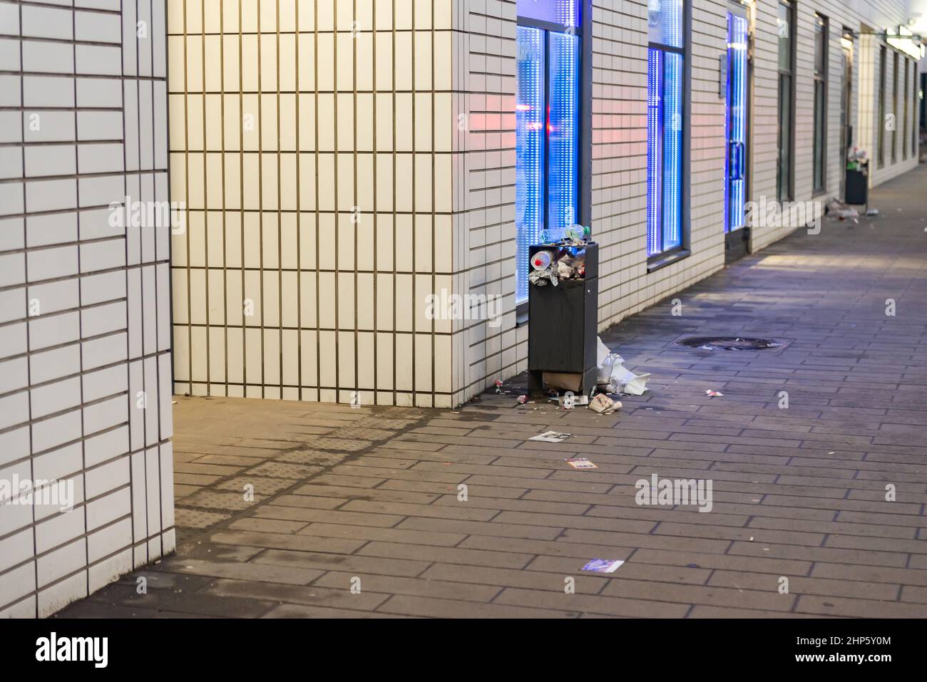 Garbage bins in the yard. An overflowing urn near the entrance of an ...