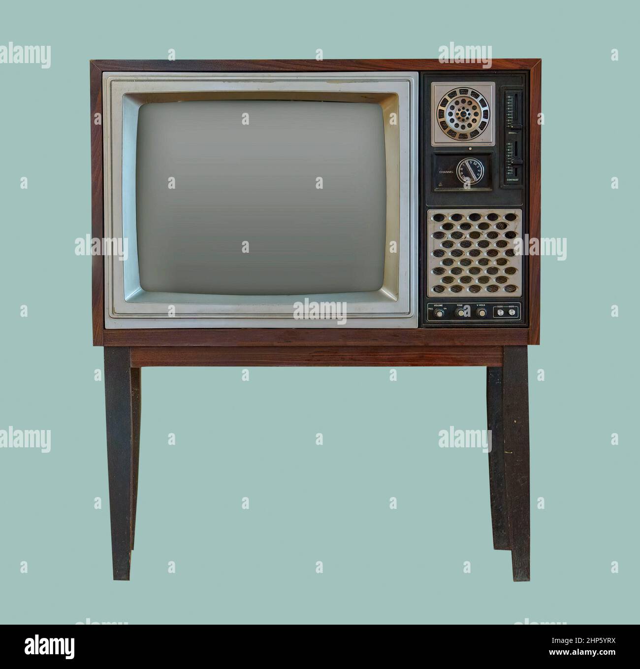 Vintage TV. Old retro TV set in wooden cabinet on isolated green background with clipping path. Stock Photo