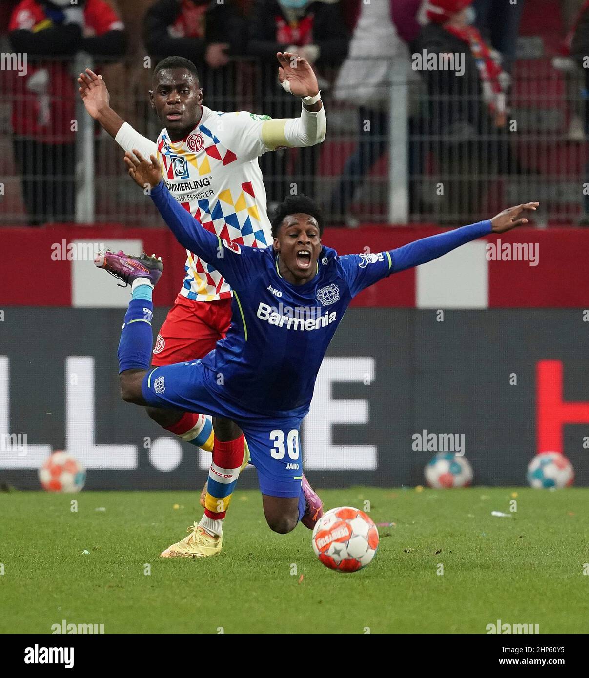 Jeremie FRIMPONG (Bayer 04 Leverkusen, #30) in a duel with Jakub KAMINSKI  (VfL Wolfsburg, #16), Stock Photo, Picture And Rights Managed Image. Pic.  PAH-321123917