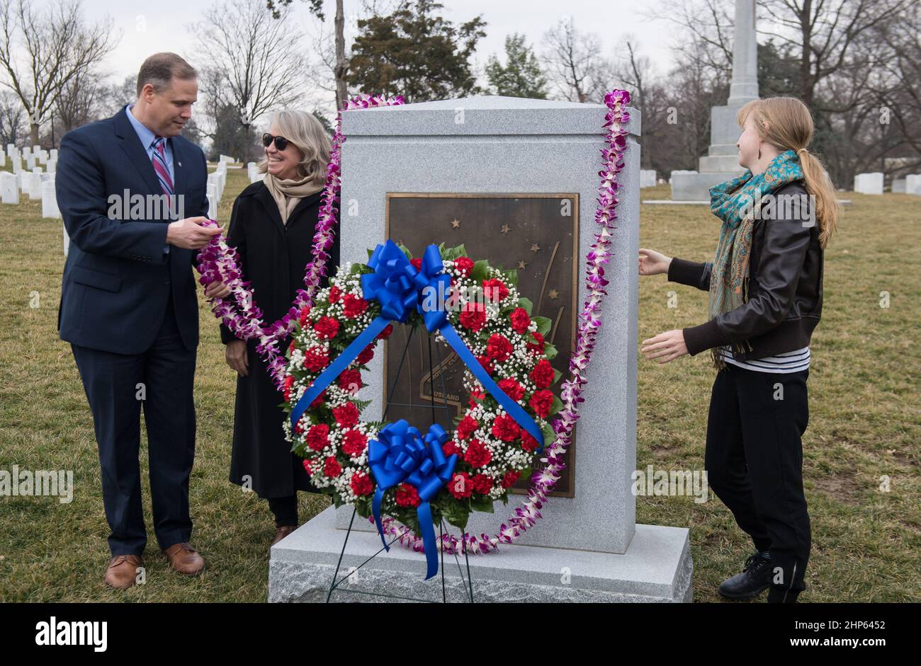 NASA Administrator Jim Bridenstine, left, helps place a lei at the Space Shuttle Columbia Memorial with Kristy Carroll, center, and daughter Vivian Carroll, who were friends of Space Shuttle Columbia pilot William McCool, during NASA's Day of Remembrance, Thursday, Feb. 7, 2019, at Arlington National Cemetery in Arlington, Va. Stock Photo