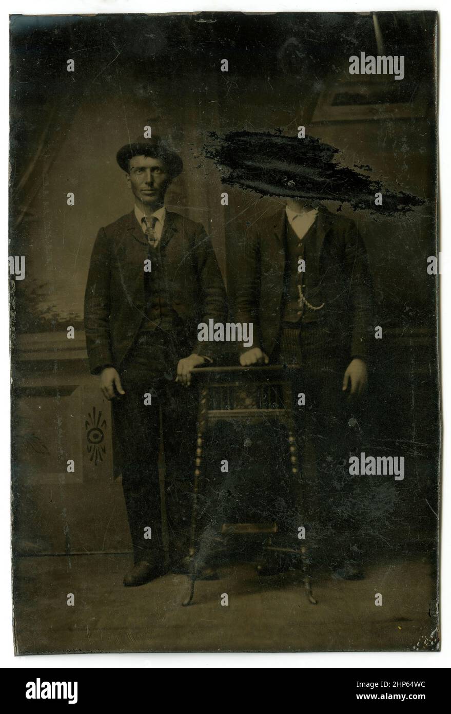 Antique circa 1860 tintype photograph, two men, one of whom has been scratched out. Location unknown, USA. SOURCE: ORIGINAL TINTYPE Stock Photo