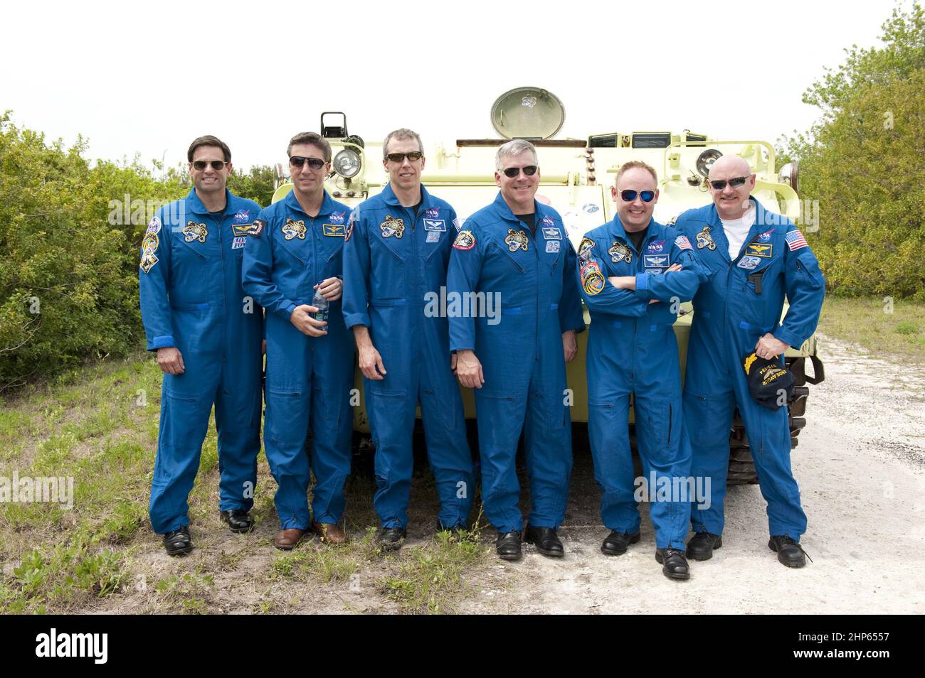 Space shuttle Endeavour's STS-134 crew members pose for a group photo in front of an M113 armored personnel carrier at NASA's Kennedy Space Center in Florida. An M113 is kept at the foot of the launch pad in case an emergency exit from the pad is needed and every shuttle crew is trained on driving the vehicle before launch. From left, are Mission Specialists Greg Chamitoff, European Space Agency astronaut Roberto Vittori and Andrew Feustel, Pilot Greg H. Johnson, Mission Specialist Michael Fincke, and Commander Mark Kelly ca. 2011 Stock Photo