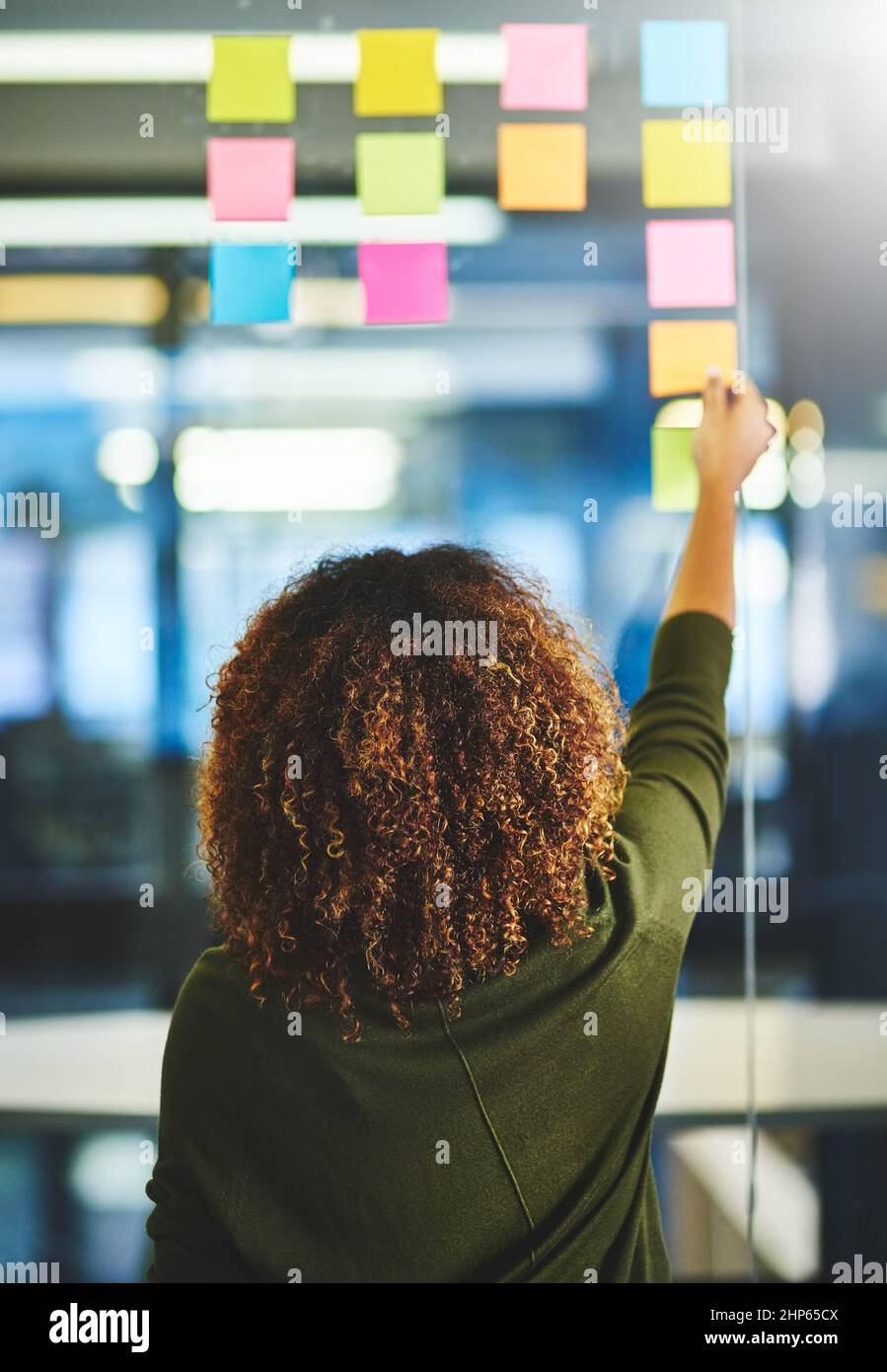 Having a solo problem solving session. Rearview shot of a woman having ...