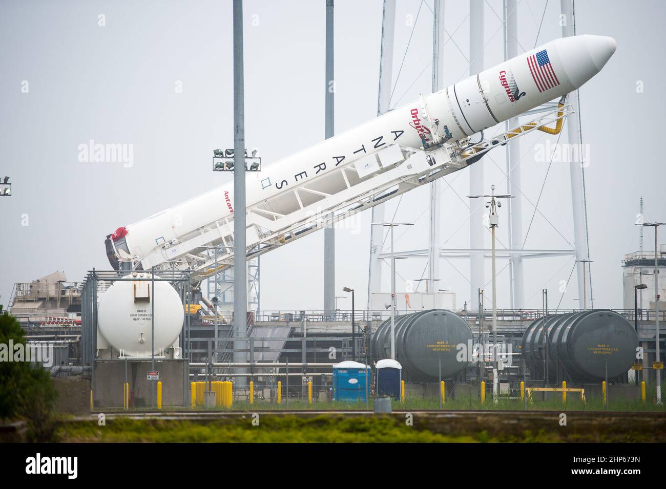 The Orbital Sciences Corporation Antares rocket, with the Cygnus spacecraft onboard, is raised at launch Pad-0A, Thursday, July 10, 2014, at NASA's Wallops Flight Facility in Virginia. Stock Photo