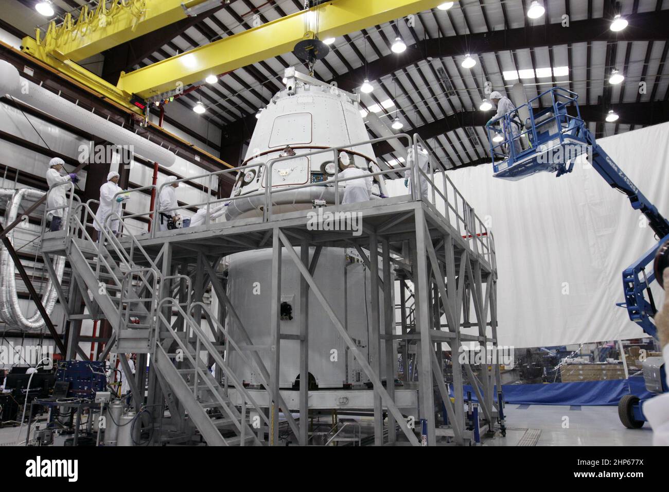 The Space Exploration Technologies Corp. (SpaceX) Dragon capsule is placed atop its cargo ring inside a processing hangar at Cape Canaveral Air Force Station in Florida ca. 2011 Stock Photo