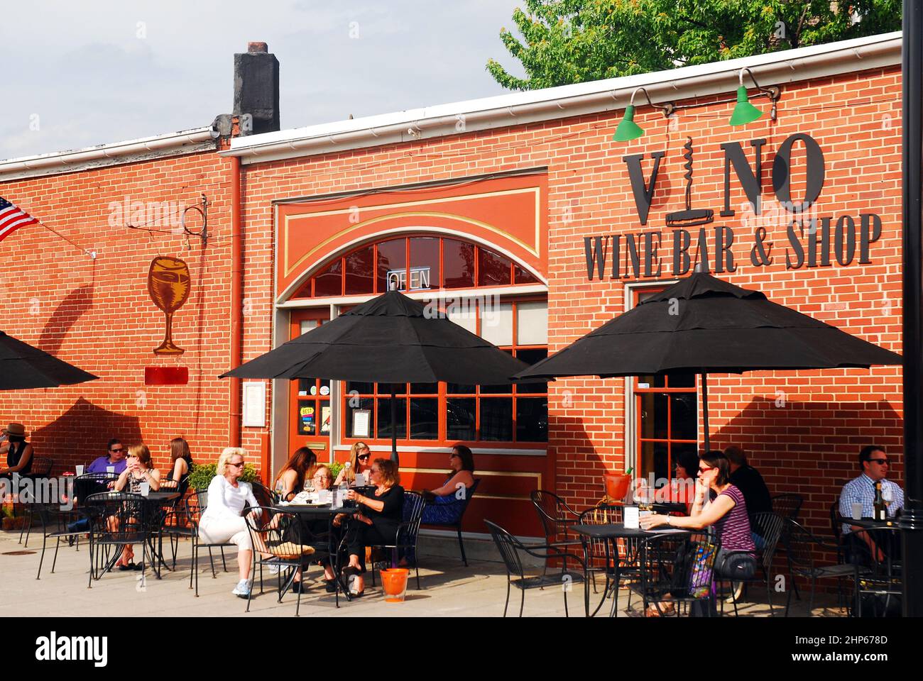 Folks enjoy a relaxing, warm spring afternoon at a wine bar in