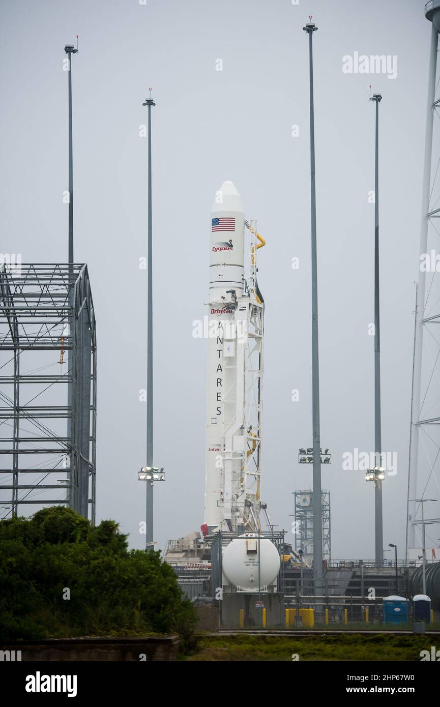 The Orbital Sciences Corporation Antares rocket, with the Cygnus spacecraft onboard, stands vertically at launch Pad-0A after successfully being raised into position for launch, Thursday, July 10, 2014, at NASA's Wallops Flight Facility in Virginia. Stock Photo