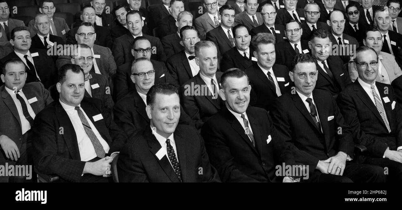 A large group of 1950s white men look at the camera at a convention, ca. 1955. Stock Photo