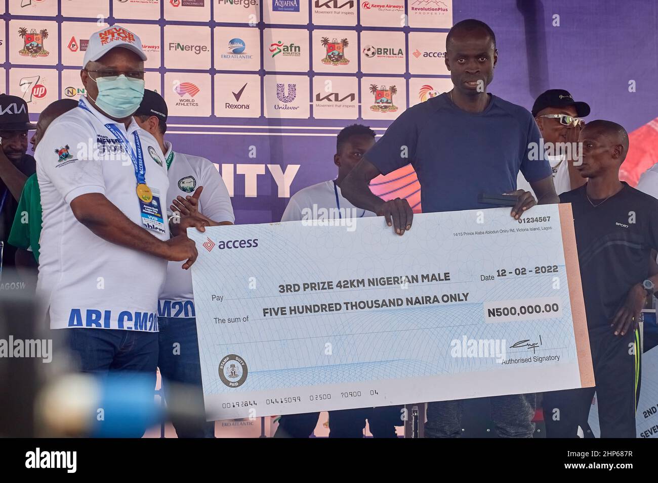 Nigerian marathon winner receives his prize money after competing in the 42km Access Bank Lagos City Marathon, on February 12, 2022. Stock Photo