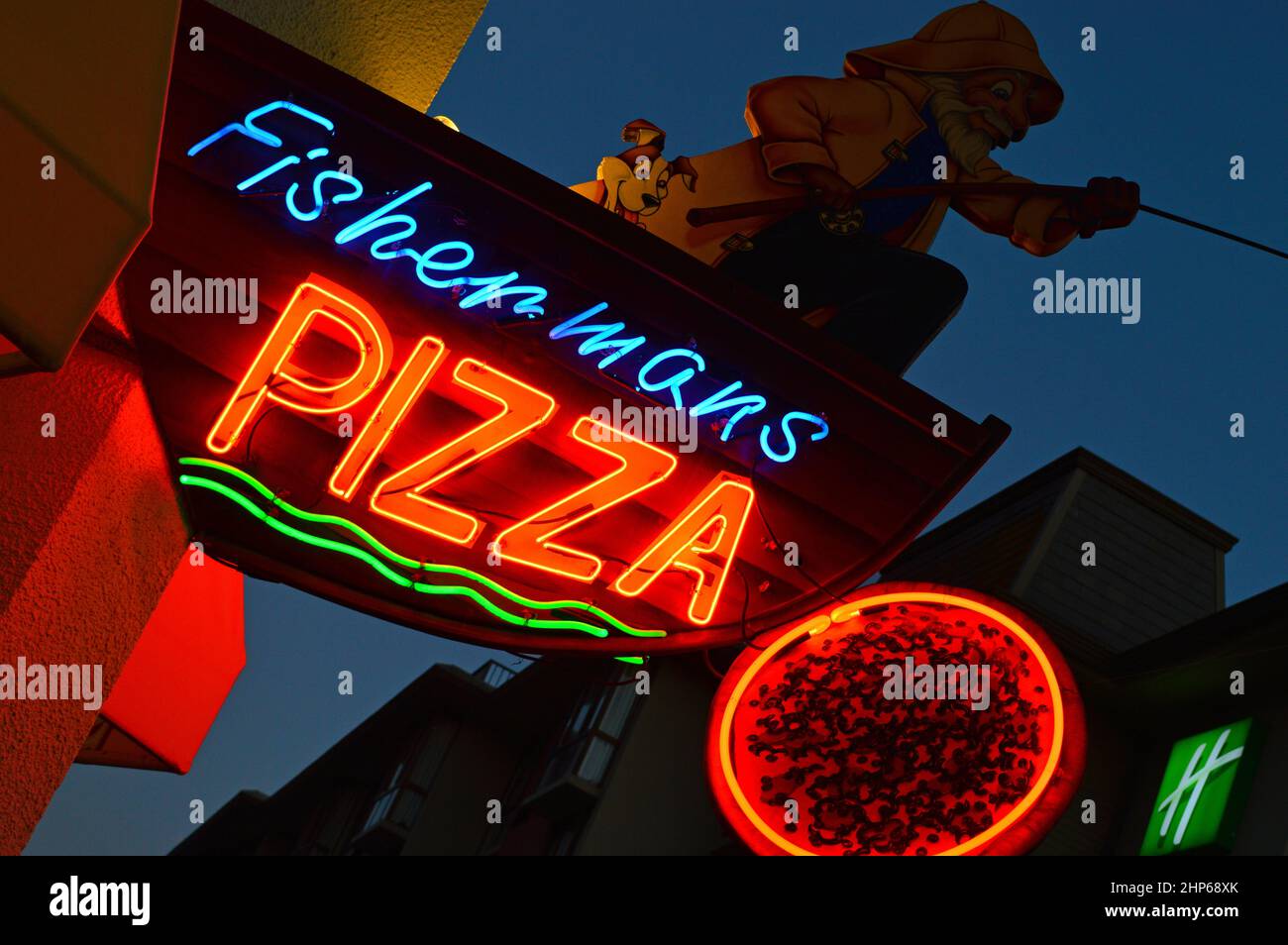 A fisherman reels in a pizza pie on a neon sign in San Francisco’s Fisherman’s Wharf Stock Photo