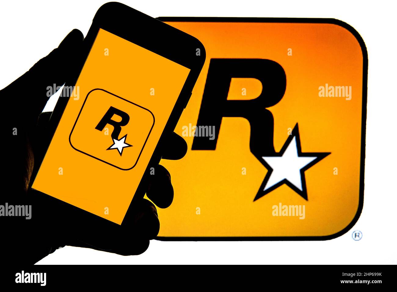 In this photo illustration a Rockstar Games logo seen displayed on a  smartphone with video games cover in the background. (Photo by Thiago  Prudencio / SOPA Images/Sipa USA Stock Photo - Alamy