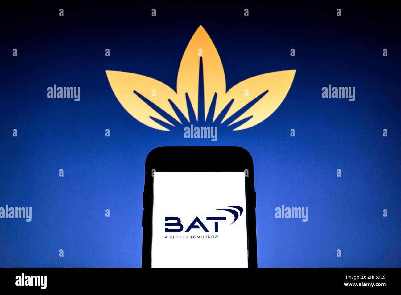 Spain. 17th Feb, 2022. In this photo illustration a British American Tobacco new logo seen displayed on a smartphone with a British American Tobacco old logo in the background. (Photo by Thiago Prudencio/SOPA Images/Sipa USA) Credit: Sipa USA/Alamy Live News Stock Photo