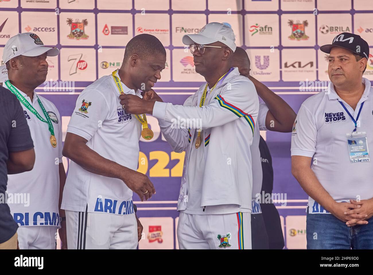 Governor of Lagos State gives a medal to the Deputy Governor of Edo State after competing in the Access Bank Lagos City Marathon on February 12, 2022. Stock Photo