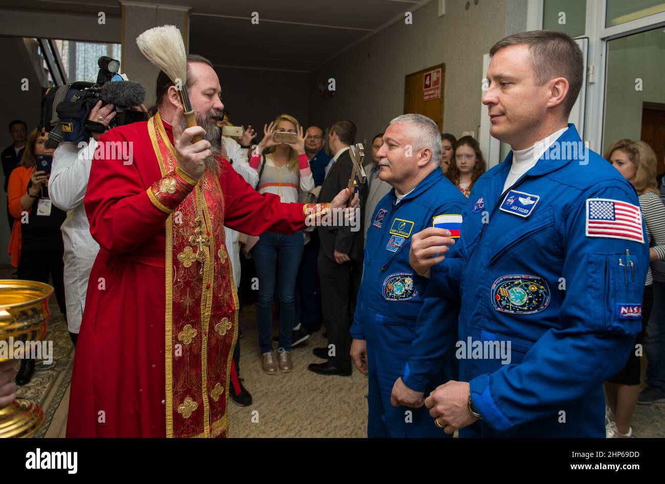 Expedition 51 Soyuz Commander Fyodor Yurchikhin of Roscosmos, left, receives the traditional blessing from a Russian Orthodox priest at the Cosmonaut Hotel prior to his launch on the Soyuz rocket to the International Space Station (ISS), Thursday, April 20, 2017, in Baikonur, Kazakhstan. He and fellow crew mate, Flight Engineer Jack Fischer of NASA, right, will spend the next four and a half months living and working aboard the ISS. Stock Photo