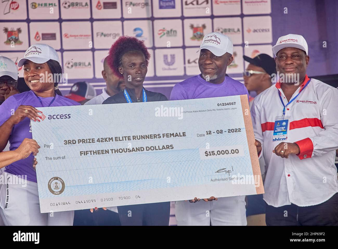 3rd place female winner, Naomi Maiyo receives a medal and prize money after competing in the Access Bank Lagos City Marathon on February 12, 2022. Stock Photo