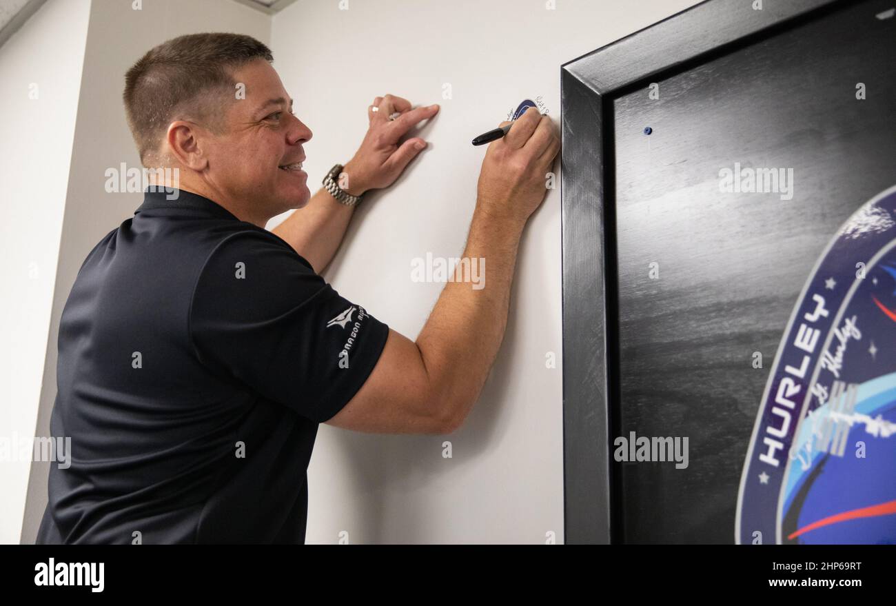 NASA astronaut Robert Behnken adds his signature to a wall inside the Astronaut Crew Quarters in the Neil A. Armstrong Operations and Checkout Building at the agency’s Kennedy Space Center in Florida ahead of NASA’s SpaceX Demo-2 mission. The launch, initially scheduled for May 27, 2020, was scrubbed due to unfavorable weather conditions around Launch Complex 39A. The next launch attempt will be Saturday, May 30. Liftoff of the SpaceX Falcon 9 rocket and Crew Dragon spacecraft is scheduled for 3:22 p.m. EDT from historic Launch Complex 39A. Behnken and crewmate Douglas Hurley will be the first Stock Photo