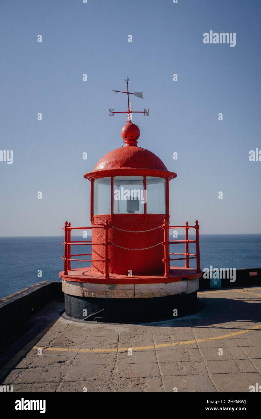 Vertical shot of a red lighthouse on a sunny day Stock Photo