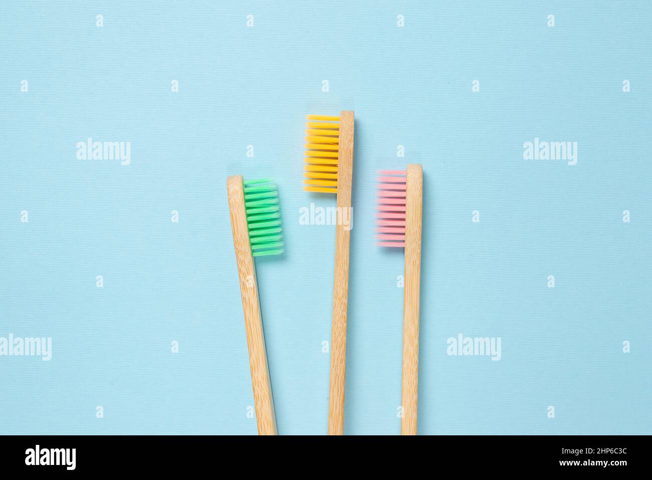 Bamboo toothbrush on a blue background. Top view Stock Photo - Alamy
