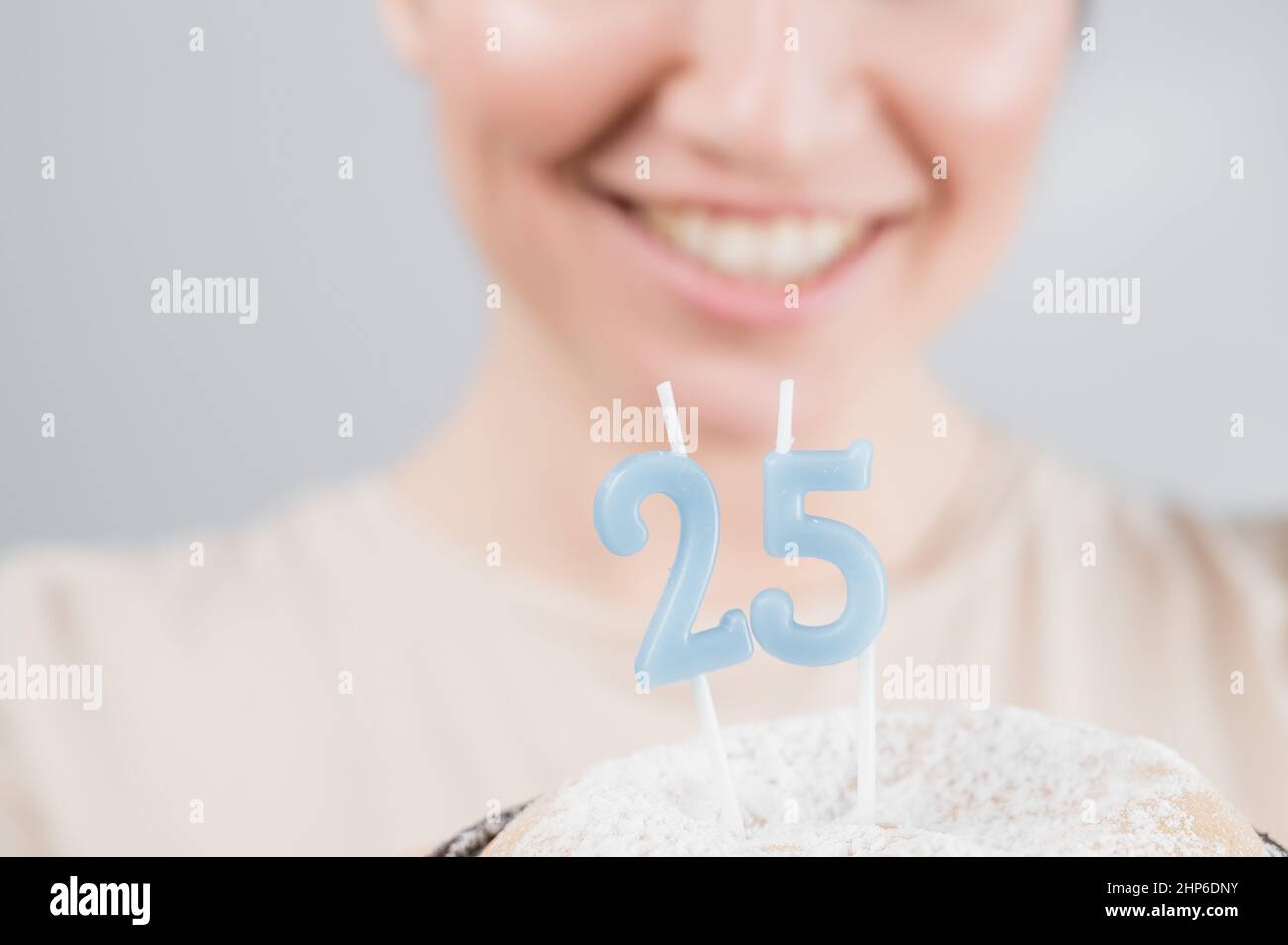 The Happy Woman Makes A Wish And Blows Out The Candles On The 25th