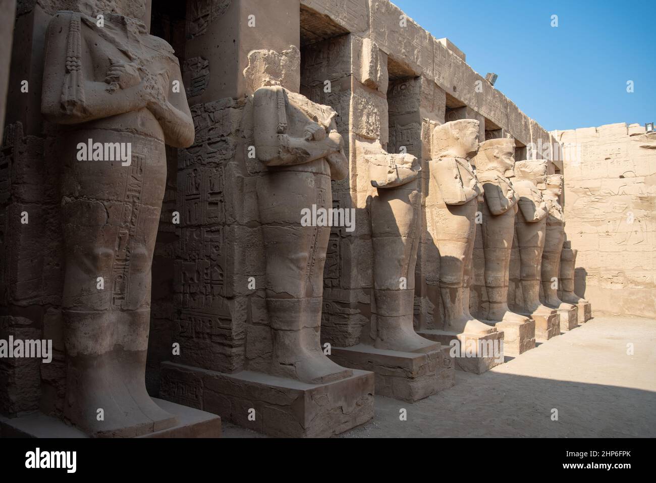 Portico with osirical statues in the courtyard of the temple of Ramses ...
