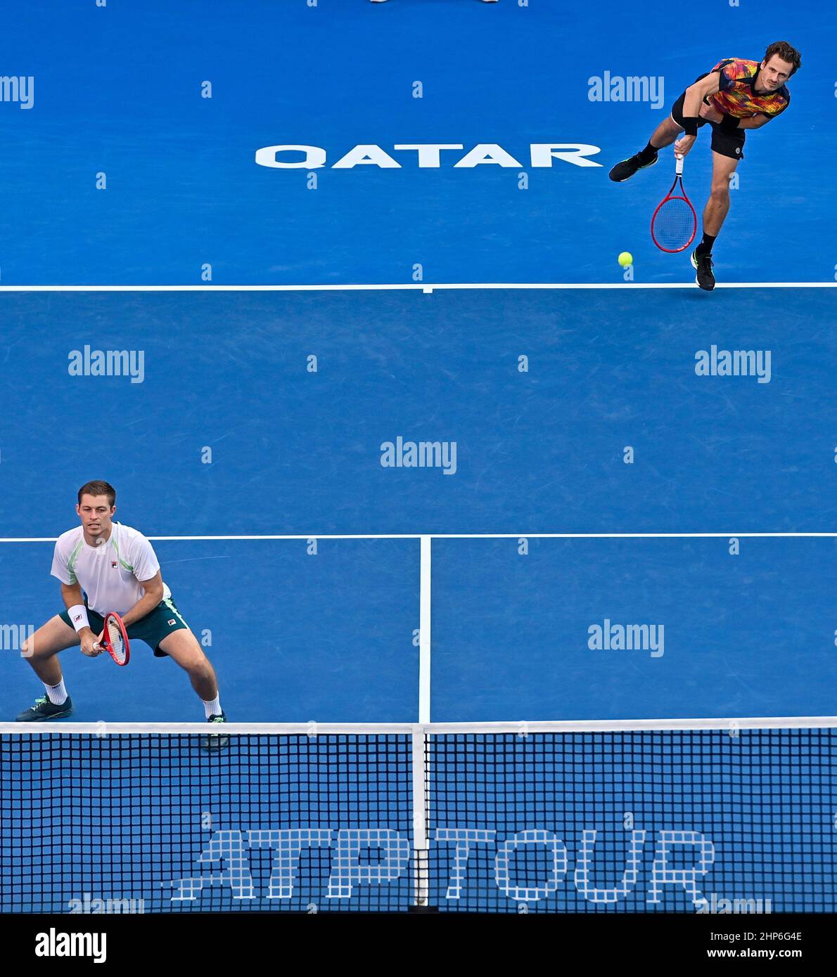 Doha, Qatar. 18th Feb, 2022. Wesley Koolhof (top) of the Netherlands and  Neal Skupski of Great Britain compete during the doubles final of ATP Qatar  Open tennis match against Rohan Bopanna of