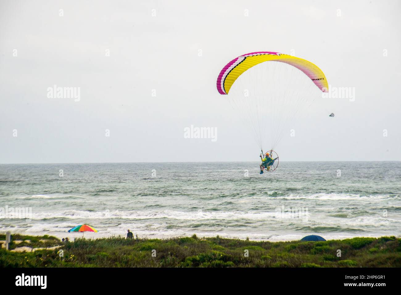 Paragliding over the ocean water Stock Photo