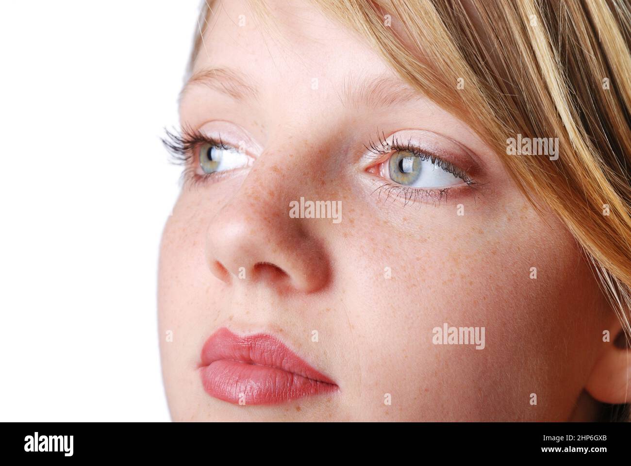 Beautiful face of young girl with green eyes and little pretty freckles Stock Photo
