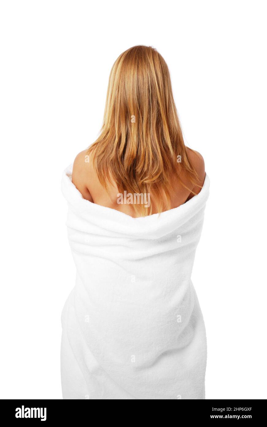 Back of beautiful young blonde woman wrapped in a big white bath towel Stock Photo