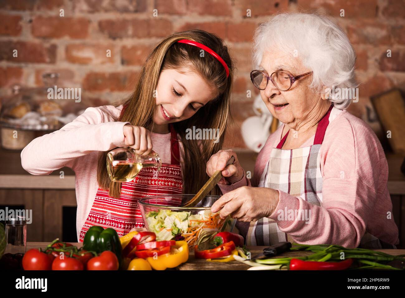 Grandmother and granddaughter cooking together Stock Photo - Alamy