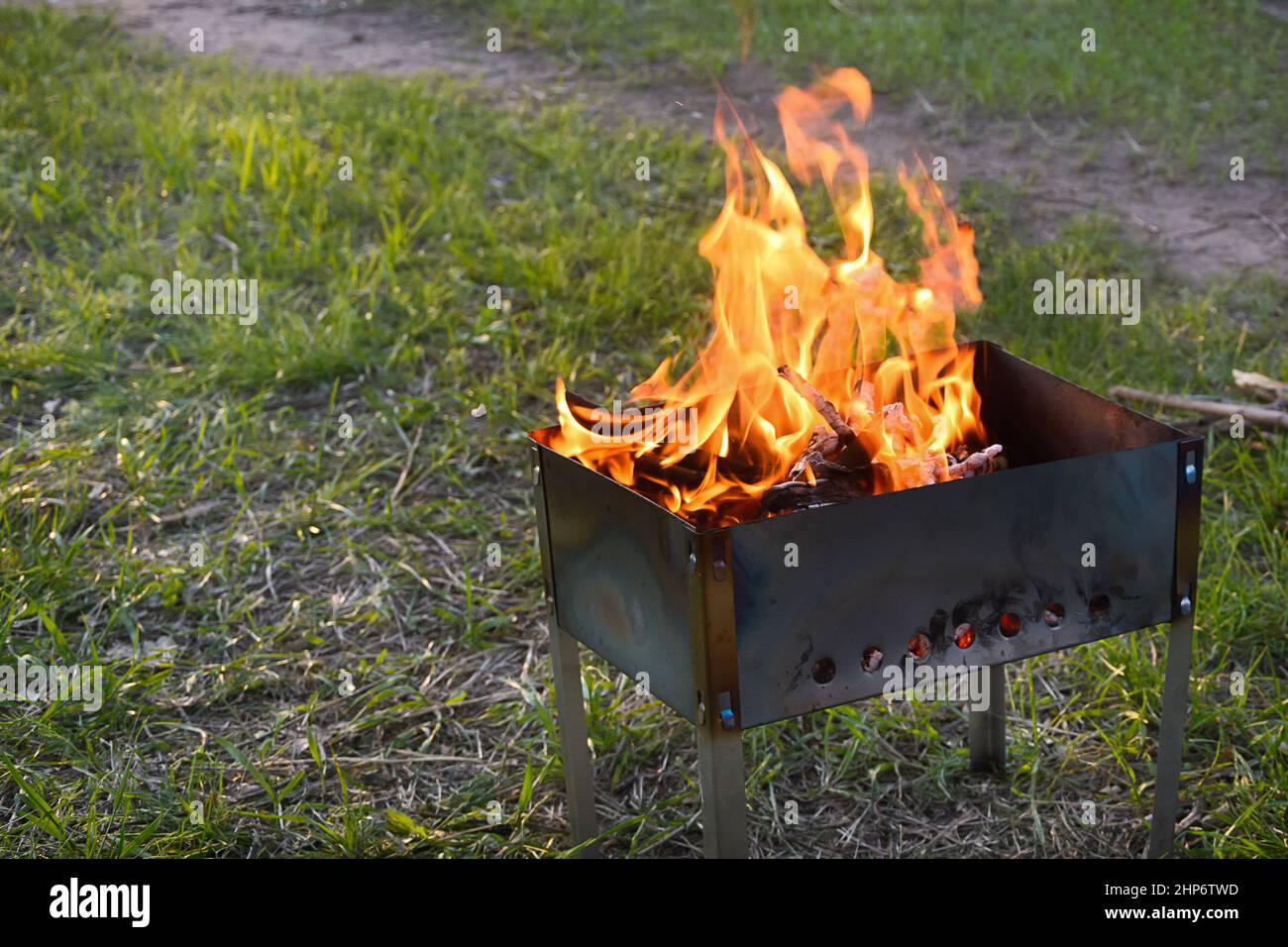 Flame of fire in iron barbecue grill. Selective frkus, type of fog. Stock Photo