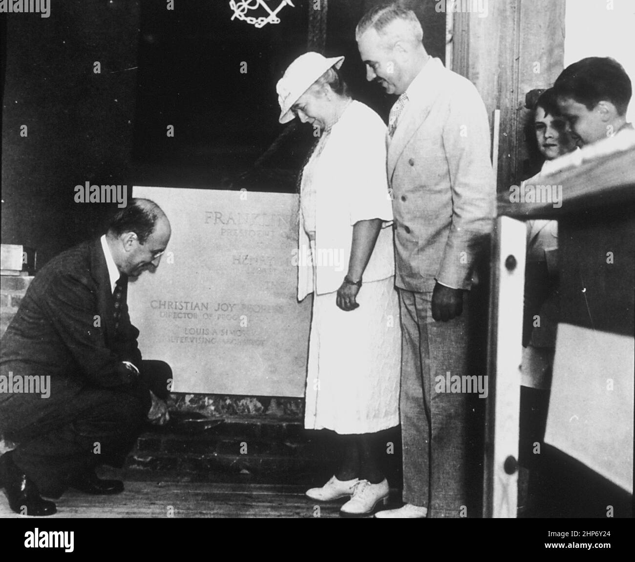 Secretary of the treasury, Henry Morgenthau wields the trowel during the cornerstone laying for the National Institutes of Health, National Cancer Institute's building 6 on June 24, 1939. Mrs. Luke Wilson, whose husband, a cancer victim, donated the land for the building, and Dr. Thomas Parron, the Surgeon General of the U.S. Public Health Service, look on.  ca.  June 1939 Stock Photo