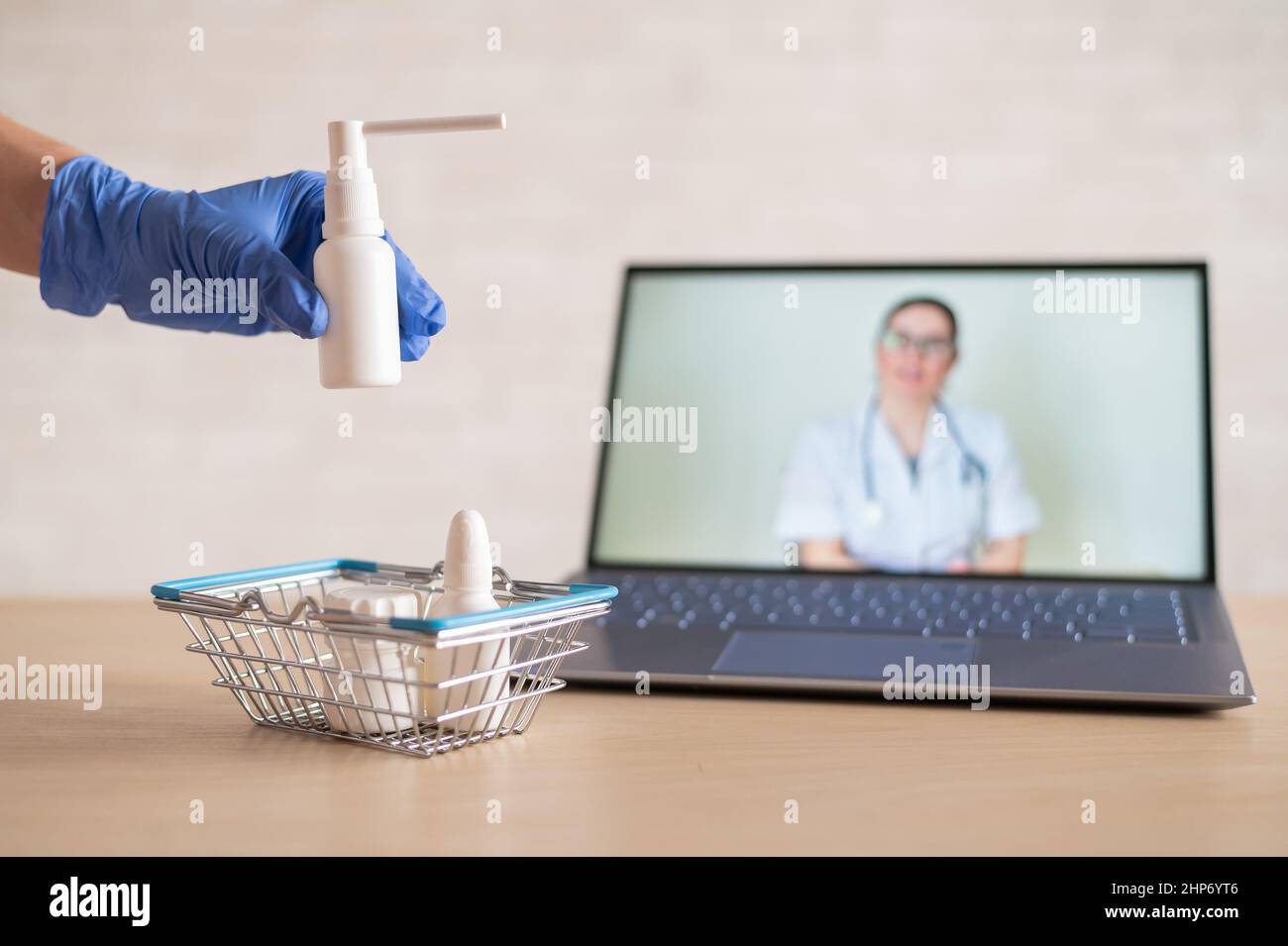 Mini Rph A friendly doctor conducts an online consultation on a laptop. A gloved ...