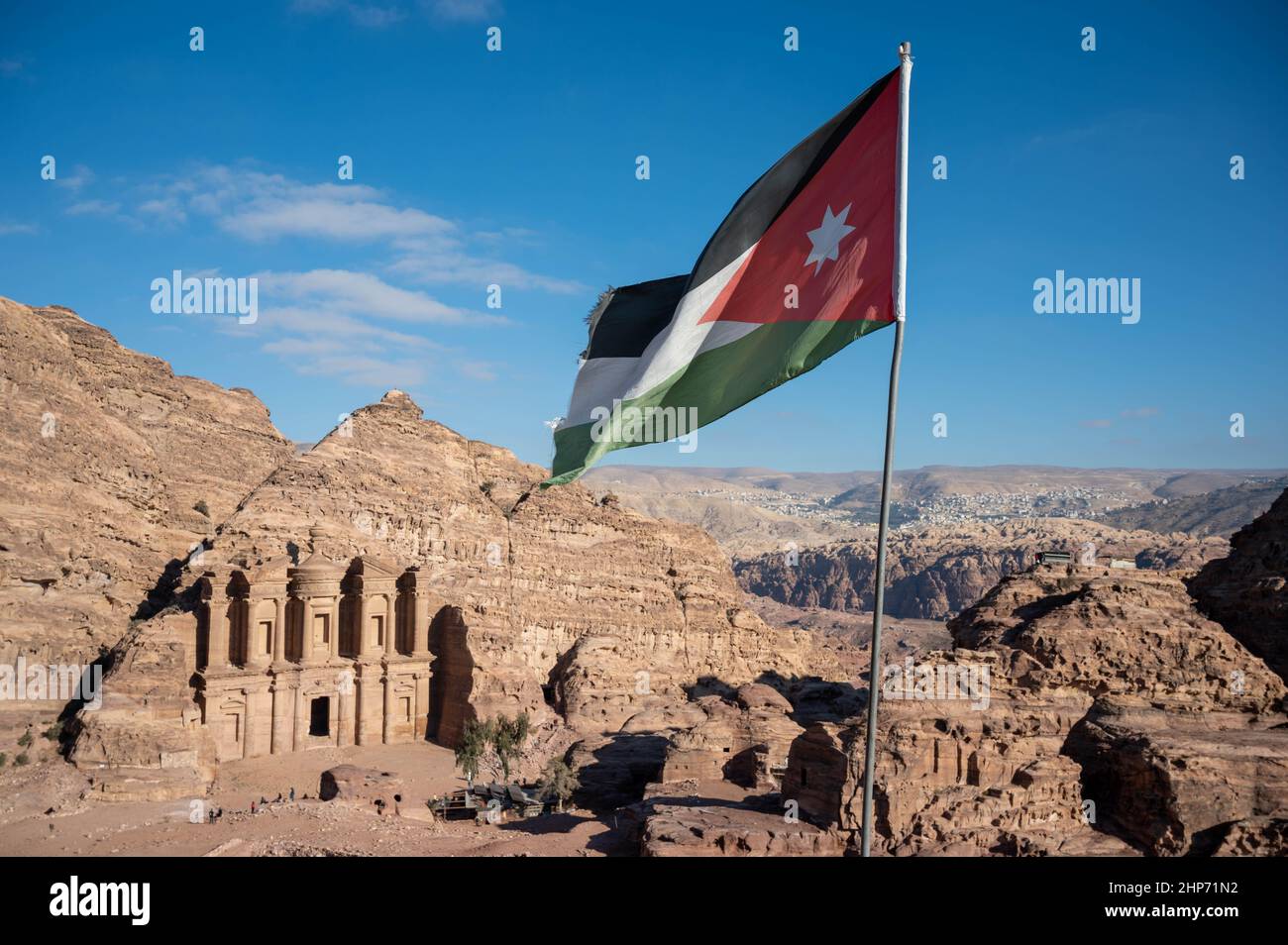 Black, white, green and red flag of Jordan flying over the tourist destination of Petra Stock Photo