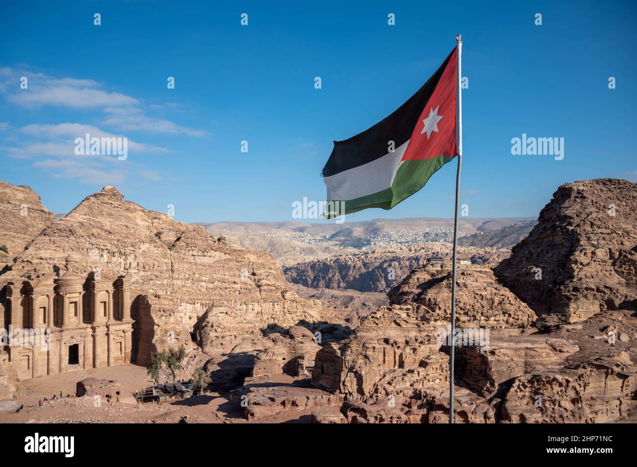 Black, white, green and red flag of Jordan flying over the tourist destination of Petra Stock Photo