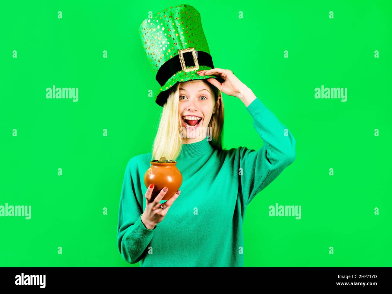 Happy girl in Green hat with pot with gold. Traditions of Saint Patricks Day. Stock Photo