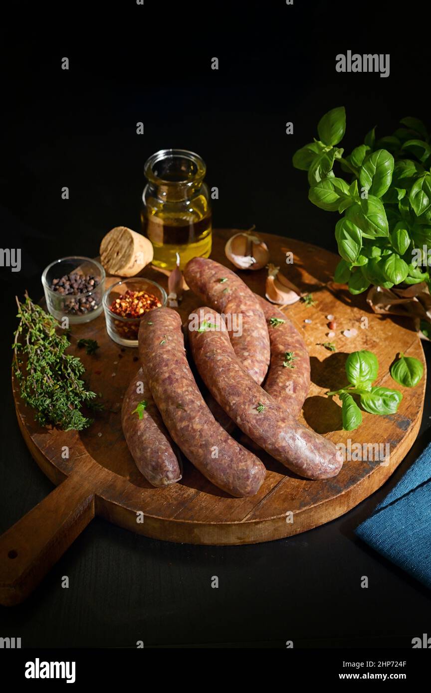 Uncooked Raw Beef And Pork Sausage Sausages and spices Stock Photo