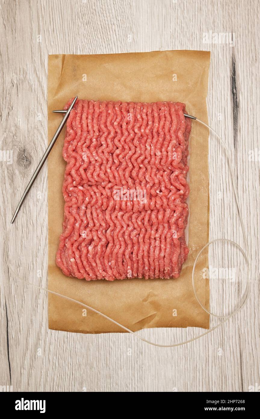 Abstract Beef Raw Minced Homemade Meat With Knitting Needles Stock Photo