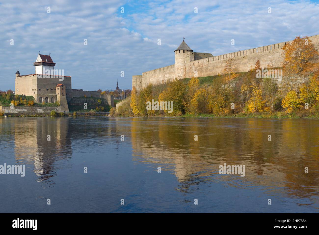 Herman's castle and Ivangorod fortress on Narva river in golden autumn. Border of Russia and Estonia Stock Photo