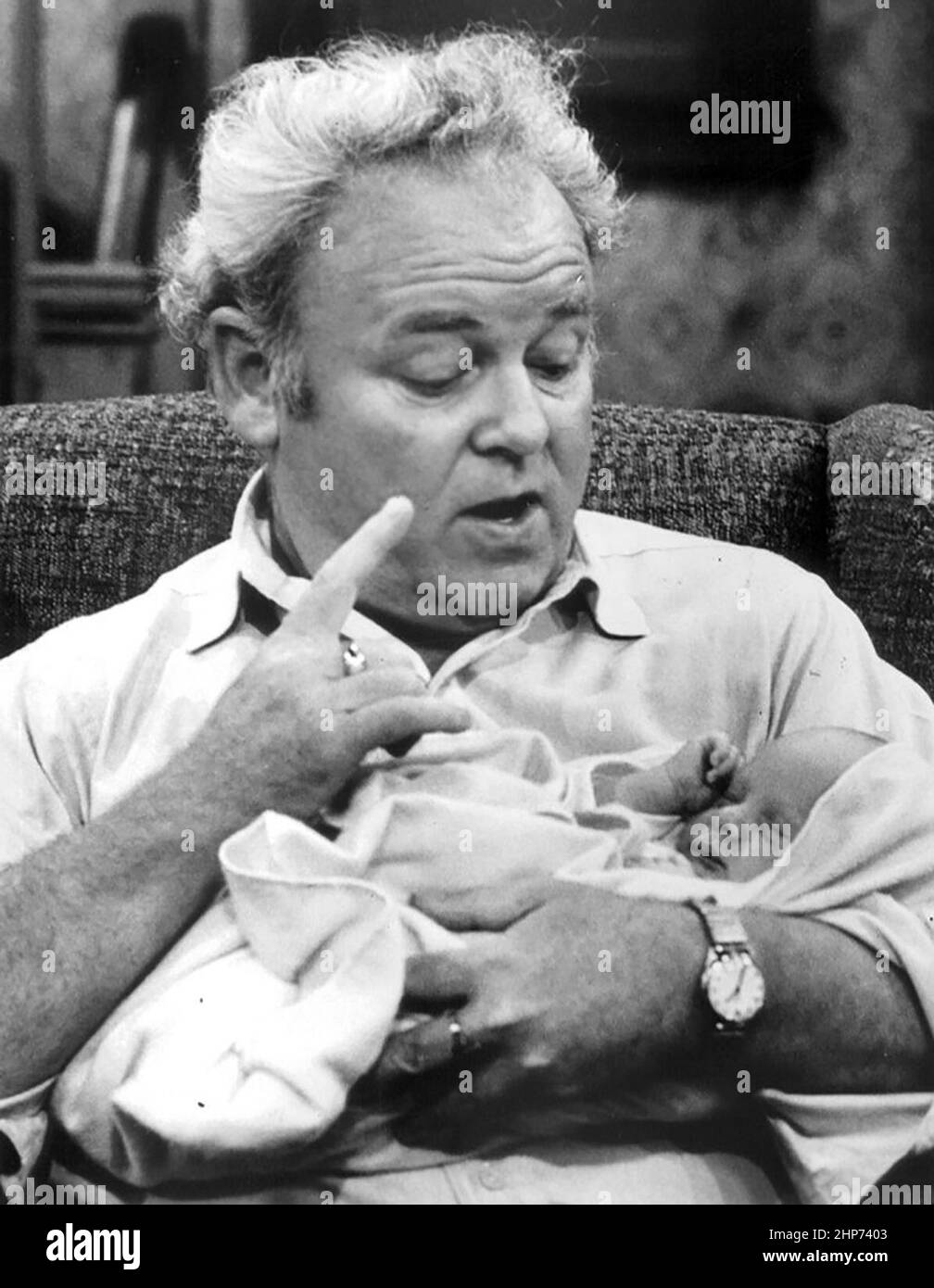 Publicity photo from  All in the Family. Pictured are Archie Bunker (Carroll O'Connor) and his new grandson, Joey Stivic Stock Photo