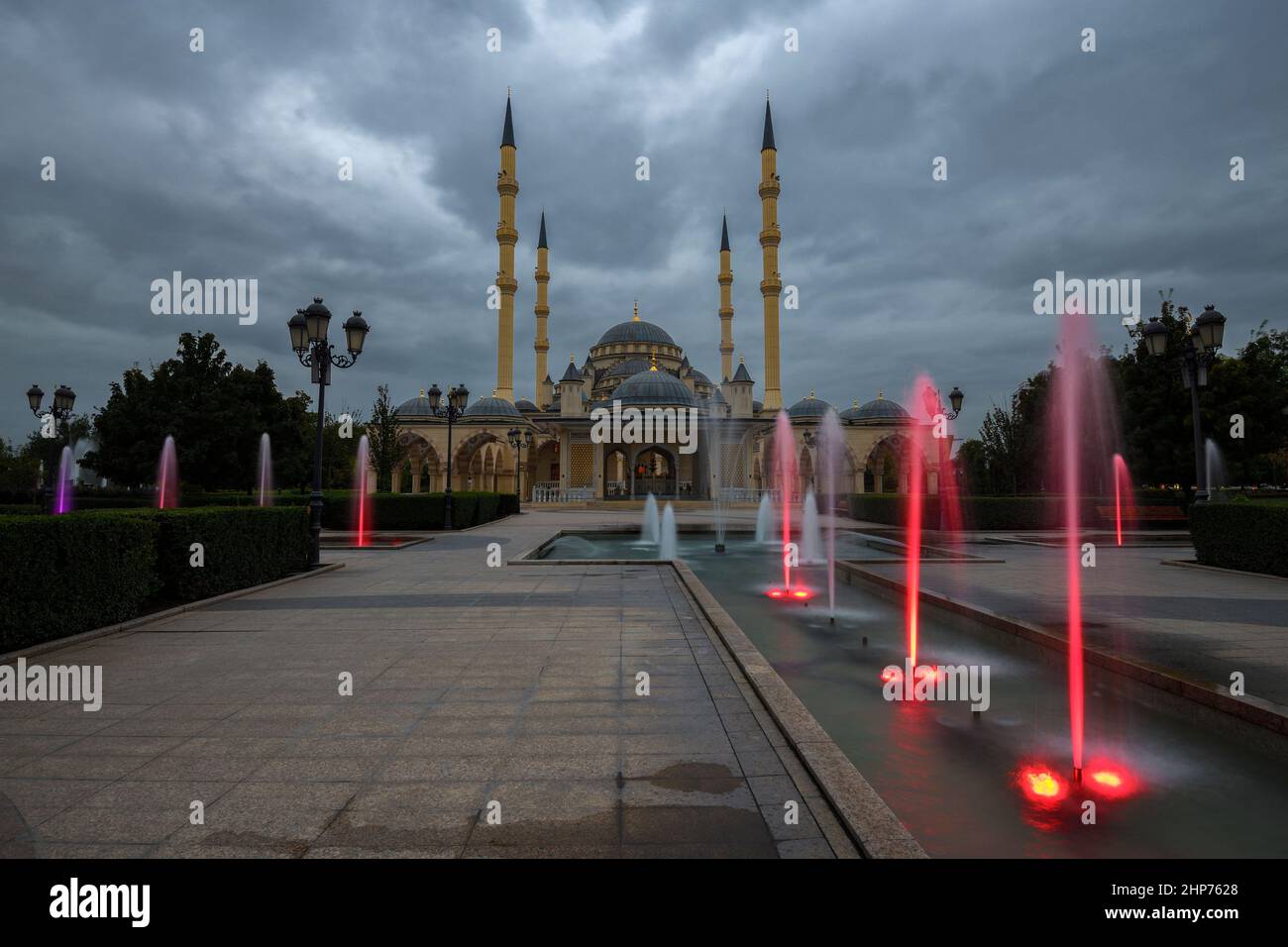 City park with fountains at the Heart of Chechnya mosque on a September twilight. Grozny, Chechen Republic.  Russian Federation Stock Photo