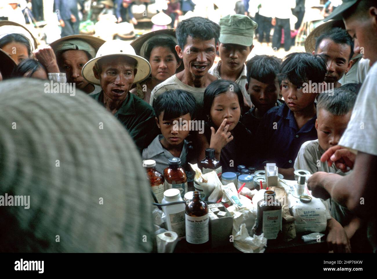Vietnam War Photos: MEDCAP (Medical Civic Action Program) for the local population outside Hill 10 during the Vietnam War - local popluation awaiting medical treatment - PD photo courtesy of USMC Stock Photo